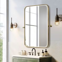 a bathroom with a sink, mirror and lights on the wall next to it in front of a window