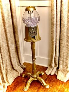 an old fashioned lamp is sitting on the floor