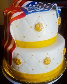 a three tiered cake decorated with an american flag and stars on the bottom layer