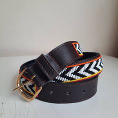 The Belts are made from ethically sourced leather in Kenya. The collars are then hand beaded by Maasai women artisans from my Village in Kajiado who have mastered the art. The hardware is made from 100% recycled brass. TO MEASURE CORRECTLY Our measurements are from the tip of the Buckle of the Collar to the second hole after the beaded section. General Belt SizeNumerical Belt SizeWaist Measurement (inches) XS 30 26.5-28 S 32 28.5-30 M 34 30.5-32 M 36 32.5-34 L 38 34.5-36 L 40 36.5-38 XL 42 38.5- Adjustable Brown Traditional Belt Buckles, Adjustable Brown Embroidered Belt, Adjustable Embroidered Brown Belt, Adjustable Brown Fabric Belt, Traditional Adjustable Leather Belt, Traditional Adjustable Brown Belt Buckles, Artisan Brown Embroidered Belt, Artisan Adjustable Fabric Belt, Traditional Leather Belts For Festivals