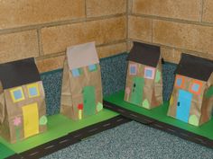 three small paper bags with houses on them