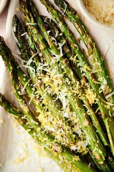 cooked asparagus with parmesan cheese and parmesan sauce on a plate