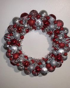 a red and silver christmas ornament wreath