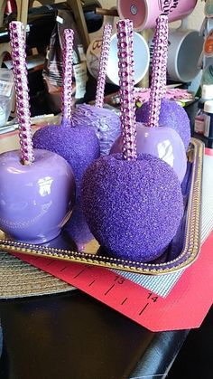 purple cake pops are in a tray on a table