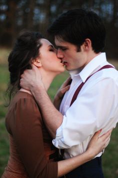 a man and woman kissing each other in front of a camera with the caption's name on it