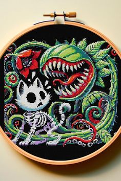 a cross stitch pattern with an image of a skeleton and a dragon on it's face