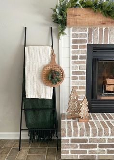 a fireplace with a towel rack and christmas decorations