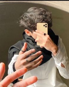 a man taking a selfie in front of a mirror with his cell phone up to his face