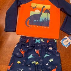 Nwt-Infant Boys Wave Zone 2-Piece Swim Shirt & Trunks Blue & Orange Long Sleeve Swim Shirt Has A Dinosaur On The Front Blue Swim Trunks With Dinosaur Design Elastic Waistband Size 12 Months. Excellent Condition Casual Orange Playtime Sets, Playful Orange Playwear Sets, Casual Orange Playwear Sets, Orange Playtime Sets For Summer, Summer Playtime Orange Sets, Orange Summer Playtime Sets, Spring Playtime Orange Sets, Playful Orange Beach Top, Fitted Orange Playwear Sets