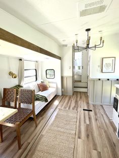 the interior of a mobile home with wood floors and white walls is shown in this image