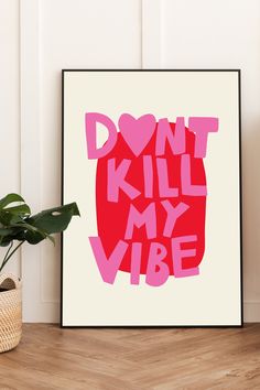 a pink poster with the words don't kill my vibe on it next to a potted plant