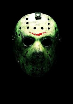 a green mask with red spots on it's face is shown in the dark