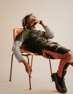 a man sitting on top of a wooden chair