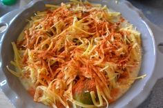 a white bowl filled with food on top of a table