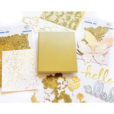 gold and white paper cut outs, dies, and other crafting supplies