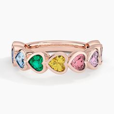 Heart Shaped Rainbow Bezel Ring - 14K Rose Gold. Glistening heart-shaped lab gemstones form a colorful and romantic look in this bezel ring. The lab sapphires, lab ruby, lab alexandrite, lab spinel, and lab emerald gems wrap around the top half of the ring for a sparkling, eye-catching design. Multicolor Rings For Valentine's Day Anniversary, Multicolor Rings For Anniversary On Valentine's Day, Multicolor Rings For Anniversary Valentine's Day, Multicolor Heart-shaped Anniversary Ring, Emerald Gem, Bezel Ring, Rose Gold Heart, Romantic Look, Jewelry Business