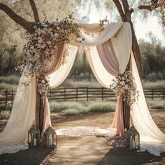 an outdoor wedding arch decorated with flowers and candles