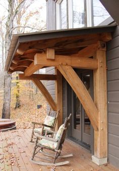 a wooden porch with rocking chairs on it