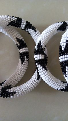 Bracelets | Custom Bracelets | Mother's Gift | Gift Idea | Bangles | Unique Gift | Bracelets For Women | Yoga Bracelets | Daughters Gift These superbly crafted Zulu beaded bracelets are made of fine beads which can be worn in any occasion. Color - White and black. Feel free to send me a convo or e-mail for any clarification. Thank you for visiting... White Beaded Bracelets With Jubilee Style, Adjustable Beaded White Bangle, White Beaded Bangle With Round Beads, Adjustable White Beaded Bangle, White Bracelets With Round Black Beads, White Bracelets With Black Beads, White Bohemian Bangle Wristband, Bohemian White Wristband With Round Beads, White Bohemian Wristband With Round Beads