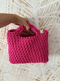 This adorable pink crochet mini handbag is perfect for the modern and trendy woman in your life. This small bag is not only fashionable but also functional, making it the ideal accessory for any outfit. It would make a lovely Christmas gift for her, adding a touch of charm to her wardrobe. Handcrafted with care, this purse is a unique and stylish addition to any collection. The bag is made of cotton cord having OEKOTEX Standard 100 Certificate. The small handbag is available in many colors.  In Trendy Pink Crochet Tote Bag, Trendy Pink Crochet Bags, Pink Rectangular Crochet Bag For Shopping, Pink Crochet Bags For Everyday Use, Pink Crochet Bag For Everyday Use, Pink Square Crochet Bag For Everyday Use, Rectangular Pink Crochet Bag For Shopping, Pink Square Crochet Bag For Gift, Pink Rectangular Crochet Bag For Everyday