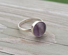 This solid sterling silver ring makes a great gift!  It has a cabochon of purple and green fluorite.  The stone is 12mm. Ring Size: 10 Band Width: 2.5mm Bezel (circle) Size: 12mm *SEE my store for cufflinks, tie clips, tie tacks, bracelets, & earrings. This would be a great gift for any time of the year! Perfect for a wedding, for a Christmas gift, anniversary gift, or a birthday. Please let me know if you have any questions. #H25 Gift Amethyst Ring With Bezel Setting In Sterling Silver, Classic Cabochon Amethyst Ring As Gift, Classic Amethyst Cabochon Ring As Gift, Silver Amethyst Ring With Bezel Setting As Gift, Silver Amethyst Ring Gift With Round Band, Gift Silver Amethyst Ring With Round Band, Silver Amethyst Ring For Gift With Round Stone, Sterling Silver Amethyst Ring For Healing, Cabochon Amethyst Ring In Sterling Silver For Anniversary