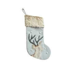 a white christmas stocking with reindeer's antlers and pearls on the bottom