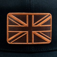 Every Head's a Throne with This British Crown Featuring an exquisite, handcrafted leather patch that showcases the vibrant Union Jack, this cap is a tribute to the spirit of Britain. This cap merges the timeless trucker style with our commitment to quality and craftsmanship. Each cap is enhanced with a unique leather patch, subtly showcasing our dedication to durability and design. Perfect for any adventure, our cap and its distinctive patch are crafted to complement your style, rain or shine. W Flag Hat, Uk Flag, Leather Stand, Pocket Notebook, Union Jack, Handcrafted Leather, Leather Patches, Full Grain Leather, Custom Fit