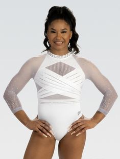 a woman in a white bodysuit posing for the camera with her hands on her hips