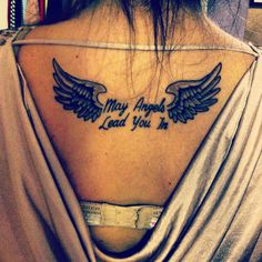 a woman with a tattoo on her back that says may angels lead you to heaven