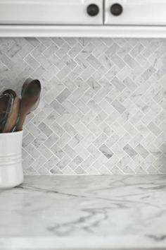 white marble kitchen counter top with utensils