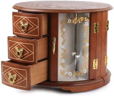 a wooden clock with three drawers on it's sides and gold trimmings