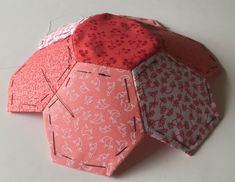 three different types of ties laid out on a white surface with red and pink designs