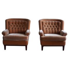 two brown chairs sitting next to each other