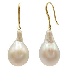 Indulge in the captivating allure of our Teardrop White Baroque Pearl Drop Earrings, meticulously crafted to inspire and captivate. These exquisite earrings showcase stunning Freshwater Cultured Baroque Pearls, boasting a brilliant white hue with a luminous luster that radiates timeless elegance. With individual weights of 15.93 carats and 15.22 carats, these teardrop-shaped pearls showcase their natural allure through their distinct shapes and mesmerizing shine. Suspended delicately from 18K Yellow Gold French Hooks, each earring emanates refinement and elegance, creating a captivating visual harmony between the soft blush of the gold and the luminous sheen of the pearls. With a total weight of 6.83 grams and a length of approximately 1.4 inches, these earrings offer a graceful and sophis Earring Video, Gold Baroque, Baroque Pearl Earrings, Pearl Diamond, Modern Earrings, Pearl Drop Earrings, Pearl Drop, Baroque Pearls, Timeless Elegance