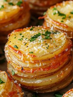 baked potatoes with parmesan cheese and herbs on top, ready to be eaten