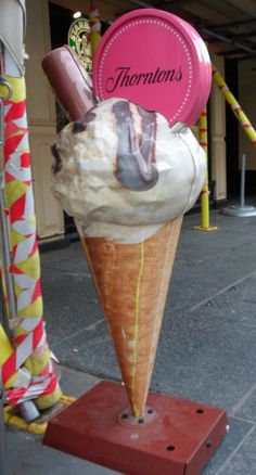 there is an ice cream cone with toppings on it