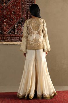 White short tunic style top with contrast embroidery. Comes with embroidered border sharara. - Aza Fashions Traditional Long Sleeve Palazzo Set With Gold Embroidery, Festive Long Sleeve Palazzo Set With Gold Embroidery, Anarkali Embroidered Tops For Eid, Embroidered Anarkali Tops For Eid, Embroidered Border Sharara For Reception, Long Sleeve Sharara With Embroidered Border For Festivals, Festive Tops With Embroidered Border For Eid, Eid Anarkali Tops With Resham Embroidery, Traditional Long Sleeve Sharara With Intricate Embroidery