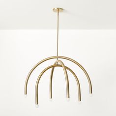 a gold chandelier with five lights hanging from it's sides and four arms