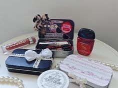 an assortment of beauty products on a table with pearls and beads around it, including lipstick