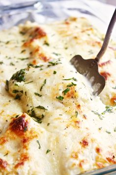 a casserole dish with cheese and herbs