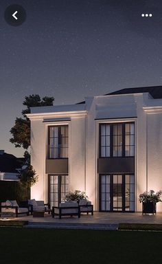 an artist's rendering of a two story house at night with lights on the windows