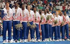 the men's gymnastics team is lined up for their medal ceremony