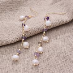 Beautiful White Pearl Earrings perfect as a Bride's Jewellery or as a Bridesmaid's Gift. The perfect choice for a unique dainty gift to your mother, daughter, best friend or just because you deserve it.  Tiny White/Ivory Fresh Water Pearls  (each pearl approximately 7-8mm long) threaded on a gold filled chain with real amethyst. Please note that by virtue of being hand-made and the nature of each pearl, shape, colour and texture may slightly vary from the photos. The earrings come in an elegant Purple Dangle Bridal Earrings, Purple Pearl Earrings For Pierced Ears As A Gift, Purple Pearl Earrings For Gift, Purple Pearl Earrings As Gift, Purple Pearl Earrings Gift, Purple Drop Bridal Earrings As Gift, Purple Pearl Drop Jewelry As A Gift, Purple Dangle Pearl Earrings As Gift, Purple Pearl Drop Jewelry For Gift