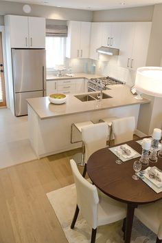 a kitchen and dining room with white furniture