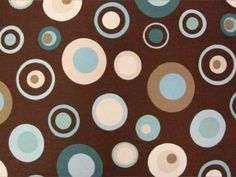 a brown background with blue and white circles on the bottom half of it, as well as an area rug in the middle