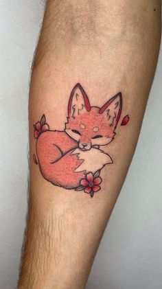 a red fox tattoo on the arm with flowers around it's neck and head