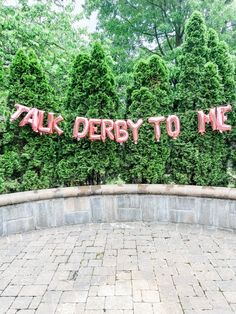 there is a sign that says talk derby to me on the side of a wall