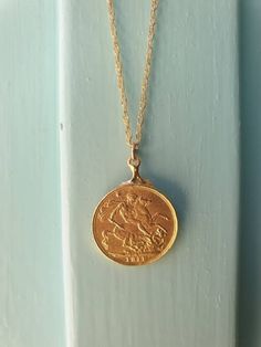 This gold coin necklace was handmade using an old gold Moroccan coin an acquainted of mine inherited from her mother. The pendant can be used on both sides. See last photo for the back side of the coin. The necklace is a quality 14k gold filled chain. The coin pendant necklace is also available in sterling silver. Dimensions: The old Moroccan coin pendent's diameter is 2.1 cm (0.8 inches) The 14k gold necklace is available in multiple lengths. This Gold coin necklace is delicate, unique and beau Antique Brass Coin Necklace With Round Pendant, Vintage Yellow Gold Brass Coin Necklace, Vintage Charm Coin Necklace For Gift, Vintage Coin Necklace Gift, Gold Coin Necklace With Vintage Charm, Yellow Gold Medallion Coin Necklace In Brass, Gold Coin Necklaces With Vintage Charm, Yellow Gold Necklace With Coin Pendant In Brass, Antique Medallion Necklace With Coin Pendant