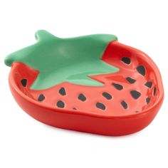 a red and green bowl with a fish on the inside, sitting in front of a white background