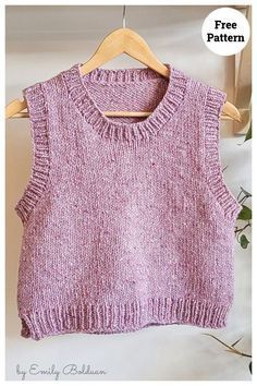 a pink knitted sweater hanging on a wooden hanger with the text free pattern